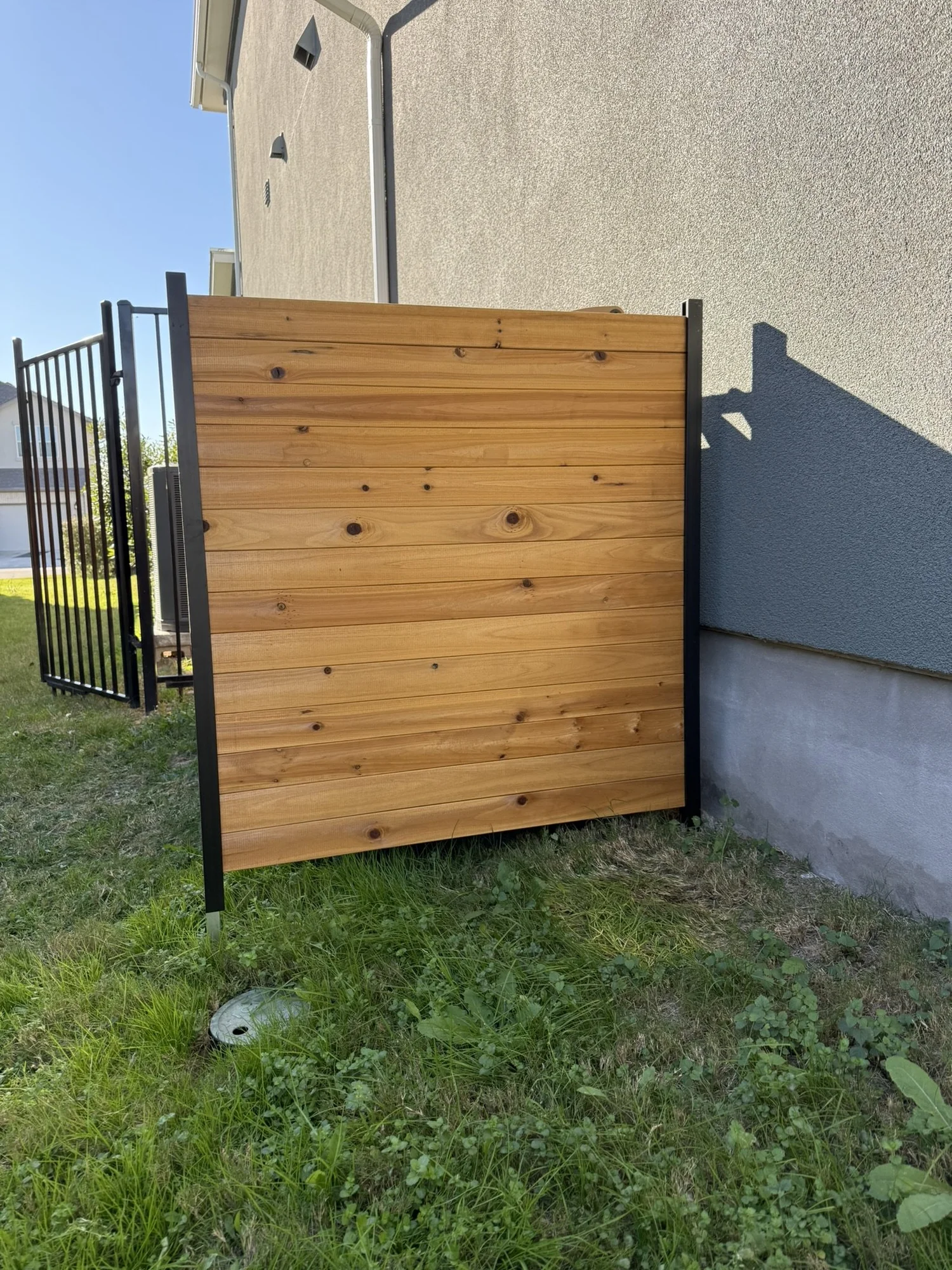 Trash bin fence installed in stone ground
